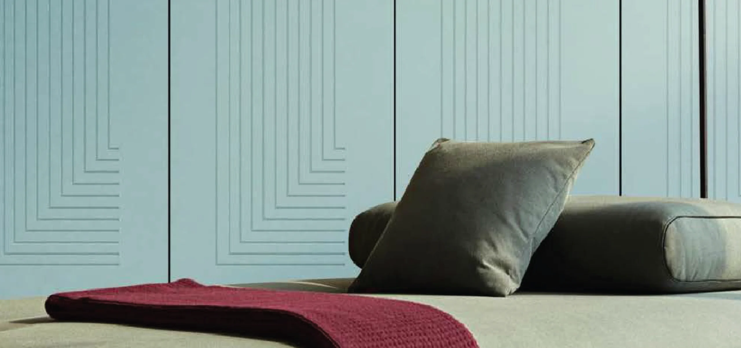 Soft blue limpido hand-crafted wall panels with subtle geometric designs, perfect for creating a serene atmosphere in modern spaces.