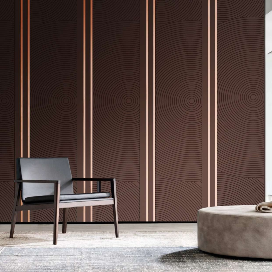 Brown handcrafted wall panel featuring concentric circles and stainless steel inlays in a modern living room.