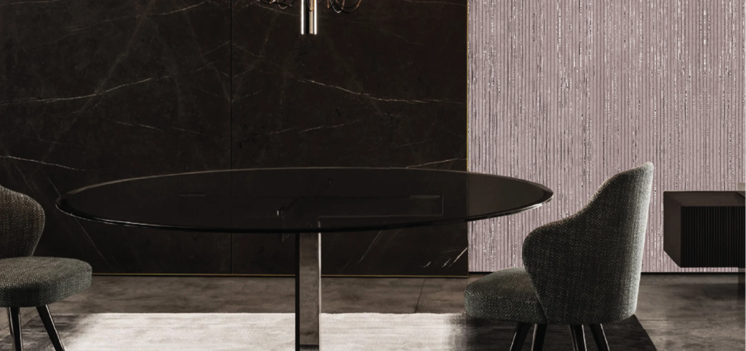 Elegant dining area with a round black glass table and modern gray fabric chairs, set against a stylish textured wall with a vertical lined pattern.