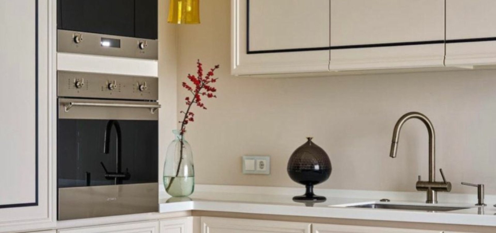 Cream and black WPC wall moulding accentuating kitchen cabinets, offering a modern and sophisticated design touch.