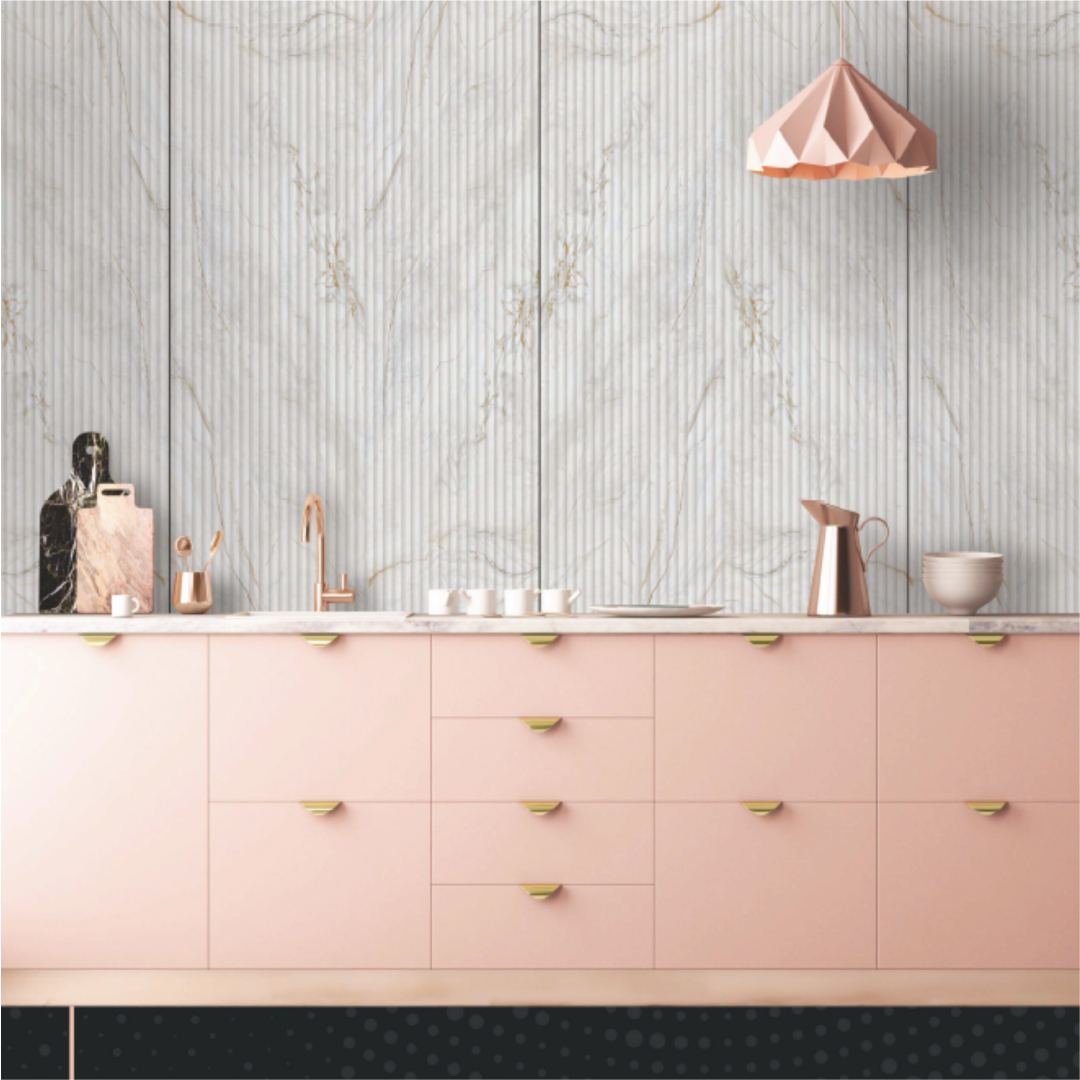 White marble fluted acrylic panel with gold vein accents in a modern kitchen with pink cabinetry.