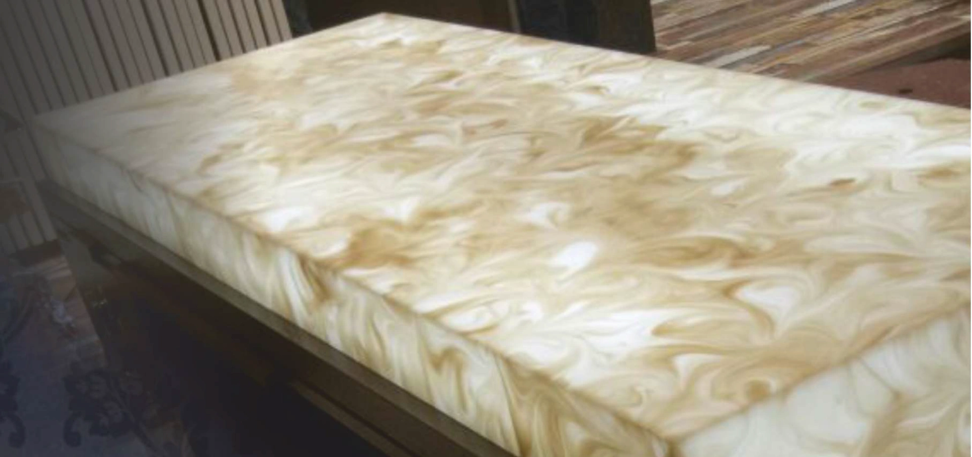 Luxurious countertop made of cream swirl alabaster onyx, showcasing a smooth and elegant texture.