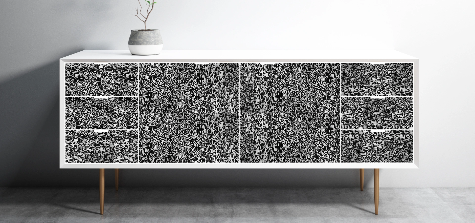 Modern sideboard with black-and-white 3D hybrid veneer detailing in abstract patterns, set against a minimalist background.