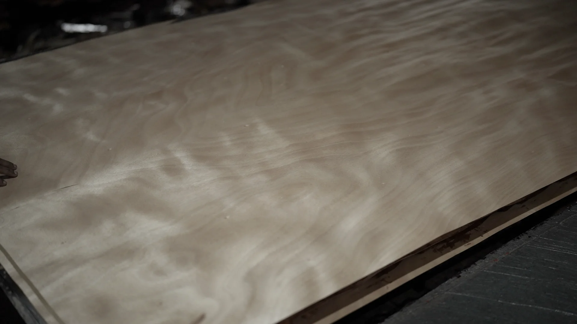 Close-up of a luxurious interior featuring intricate natural wood veneer patterns on the walls, creating a refined atmosphere.